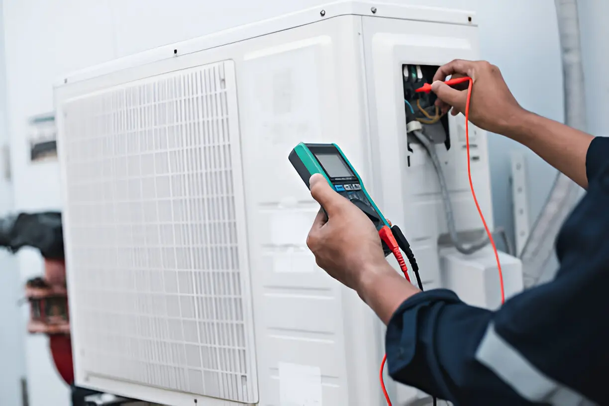 HVAC technician performing emergency AC repair on an outdoor unit in Orlando